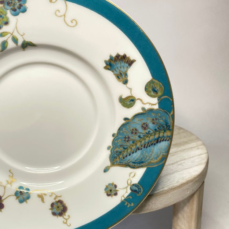 Decorative plate with blue and gold floral patterns on a white background